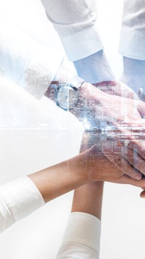 Business team joining hands together city background